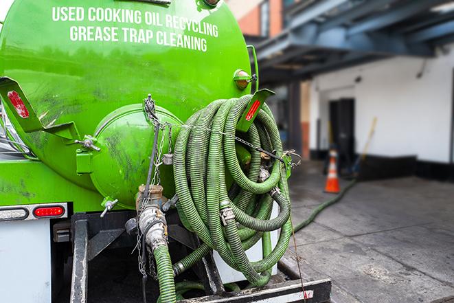 a grease trap being pumped by a sanitation technician in Irvington NY